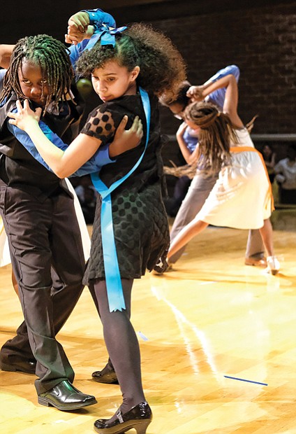 Julius Jackson, left, and Tristan Albers of Chimborazo Elementary School perform the tango at the Dancing Classrooms GRVA Colors of the Rainbow Team Match in April.