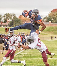 Virginia State University tailback Trenton “Boom” Cannon goes airborne for a touchdown in the Trojans’ nail-biting 40-39 victory over Virginia Union University on Nov. 4.