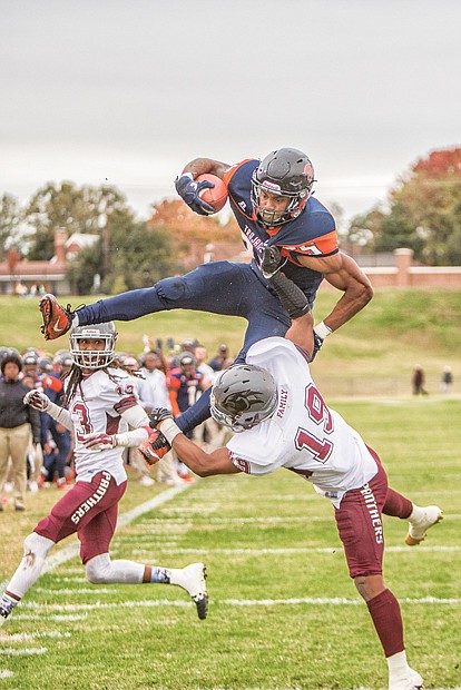 Virginia State University tailback Trenton “Boom” Cannon goes airborne for a touchdown in the Trojans’ nail-biting 40-39 victory over Virginia Union University on Nov. 4.