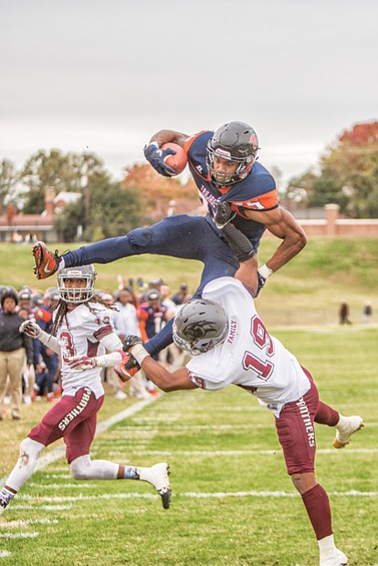 Virginia State University tailback Trenton “Boom” Cannon goes airborne for a touchdown in the Trojans’ nail-biting 40-39 victory over Virginia Union University on Nov. 4.