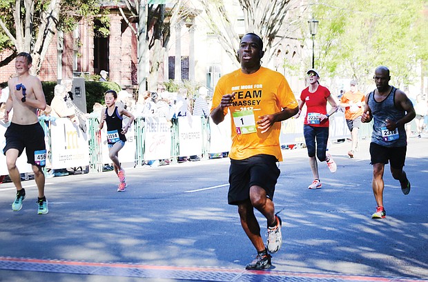 Mayor Stoney, a former high school track and football star, takes part in the Monument Avenue 10K last April. 