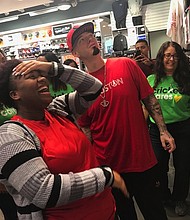 YES Prep senior Davenese Bailey shares her excitement with Houston rapper Paul Wall while shopping for shoes at The Galleria. Cricket Wireless marketing manager Susan Cochran (right) joins them. Cricket Wireless was the sponsor of the “surprise” holiday shopping spree for the students.