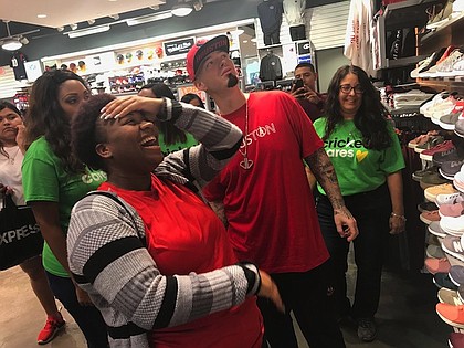 YES Prep senior Davenese Bailey shares her excitement with Houston rapper Paul Wall while shopping for shoes at The Galleria. Cricket Wireless marketing manager Susan Cochran (right) joins them. Cricket Wireless was the sponsor of the “surprise” holiday shopping spree for the students.