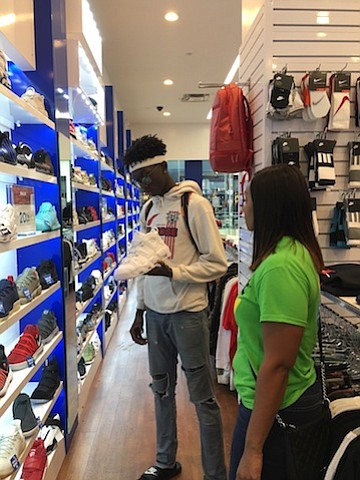  YES Prep junior Jason Akpabio shops for shoes at The Galleria, the surprise recipient of a $1000 holiday shopping spree from Cricket Wireless.