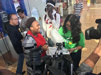 YES Prep student Davenese Bailey is all smiles during a surprise holiday shopping spree at The Galleria. 