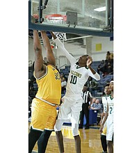 Huguenot High’s 7-foot center Eric Rustin goes up against Prince George High’s 6-foot-10 Christian Chappell during the Tri-City Holiday Classic, dubbed the “Battle of the Bigs,” on Dec. 27. Huguenot won 67-62 in the game’s final seconds.