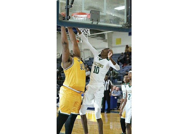 Huguenot High’s 7-foot center Eric Rustin goes up against Prince George High’s 6-foot-10 Christian Chappell during the Tri-City Holiday Classic, dubbed the “Battle of the Bigs,” on Dec. 27. Huguenot won 67-62 in the game’s final seconds.