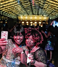 Later Sunday night, the 18-and-older crowd turned out for “Le Masque 007 NYE Celebration” at the Main Street Station train shed. About 250 people attended the party that had a James Bond Casino Royale theme.  Malekah Mason, left, and Myaira Mason, ring in 2018 with champagne and a selfie at the event. 