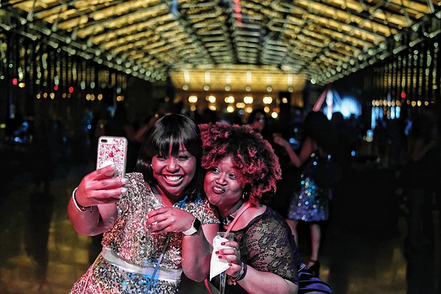 Later Sunday night, the 18-and-older crowd turned out for “Le Masque 007 NYE Celebration” at the Main Street Station train shed. About 250 people attended the party that had a James Bond Casino Royale theme.  Malekah Mason, left, and Myaira Mason, ring in 2018 with champagne and a selfie at the event. 