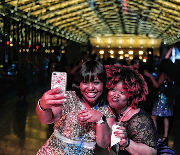 Later Sunday night, the 18-and-older crowd turned out for “Le Masque 007 NYE Celebration” at the Main Street Station train shed. About 250 people attended the party that had a James Bond Casino Royale theme.  Malekah Mason, left, and Myaira Mason, ring in 2018 with champagne and a selfie at the event. 