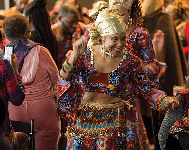 Celebrating Kwanzaa //  The festival included a procession of drummers and dancers led by Janine Bell, bottom left, founder and artistic director of the Elegba Folklore Society that produces the annual celebration. 
