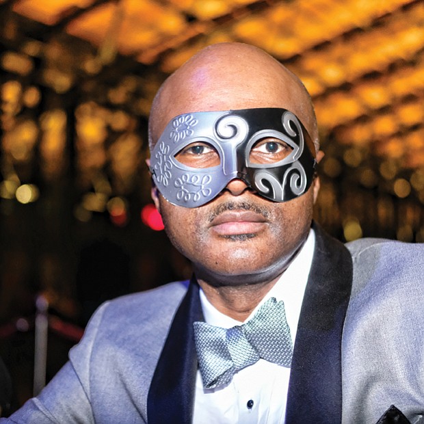 Ringing in the new year! // Joe Foster goes for an air of mystery and intrigue in his mask and bow tie. 
