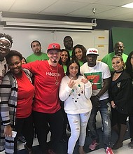 YES Prep students Jason Akpabio, Davenese Bailey and Eden Umanzor flank Houston rapper Paul Wall and friends after learning they’re the lucky winners of a holiday shopping spree at The Galleria