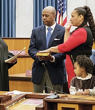 Swearing-in //
Richmond’s new city treasurer, Nichole Richardson Armstead, is sworn in last Saturday by Richmond General District Court Judge Jacqueline S. McClenney during a ceremony in Council Chambers in Richmond City Hall. Mrs. Armstead was elected to the $83,594 post in November, succeeding longtime treasurer Eunice M. Wilder, who retired. Her husband, Stafford L. Armstead, holds the Bible during the ceremony, while their children watch. They are, from left, Katrina, Richardson and Stafford II. Mrs. Armstead, a project management consultant, has 17 years of experience with the Federal Reserve Bank of Richmond. She is the daughter of former Richmond City Councilman Henry W. “Chuck” Richardson.