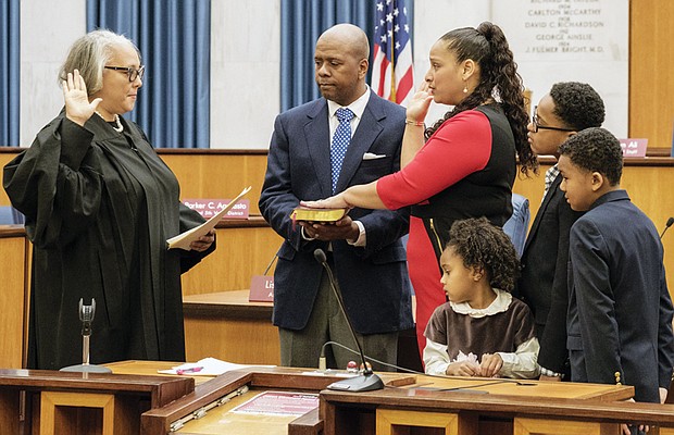 Swearing-in //
Richmond’s new city treasurer, Nichole Richardson Armstead, is sworn in last Saturday by Richmond General District Court Judge Jacqueline S. McClenney during a ceremony in Council Chambers in Richmond City Hall. Mrs. Armstead was elected to the $83,594 post in November, succeeding longtime treasurer Eunice M. Wilder, who retired. Her husband, Stafford L. Armstead, holds the Bible during the ceremony, while their children watch. They are, from left, Katrina, Richardson and Stafford II. Mrs. Armstead, a project management consultant, has 17 years of experience with the Federal Reserve Bank of Richmond. She is the daughter of former Richmond City Councilman Henry W. “Chuck” Richardson.