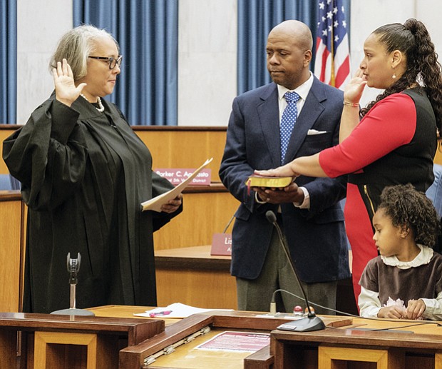 Swearing-in //
Richmond’s new city treasurer, Nichole Richardson Armstead, is sworn in last Saturday by Richmond General District Court Judge Jacqueline S. McClenney during a ceremony in Council Chambers in Richmond City Hall. Mrs. Armstead was elected to the $83,594 post in November, succeeding longtime treasurer Eunice M. Wilder, who retired. Her husband, Stafford L. Armstead, holds the Bible during the ceremony, while their children watch. They are, from left, Katrina, Richardson and Stafford II. Mrs. Armstead, a project management consultant, has 17 years of experience with the Federal Reserve Bank of Richmond. She is the daughter of former Richmond City Councilman Henry W. “Chuck” Richardson.