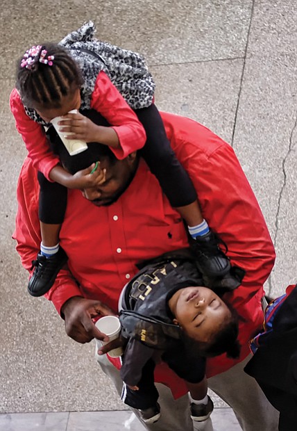 Ringing in the new year! // Darius Robinson Sr. had his hands full at the museum party, with his daughter, Mariah, 3, on his shoulders and year-old son, Darius Jr., out like a light on his arm. 
