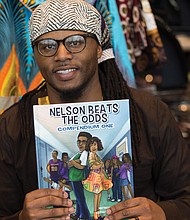 Author Ronnie Sidney, a licensed clinical social worker, displays one of his children’s books at the festival marketplace