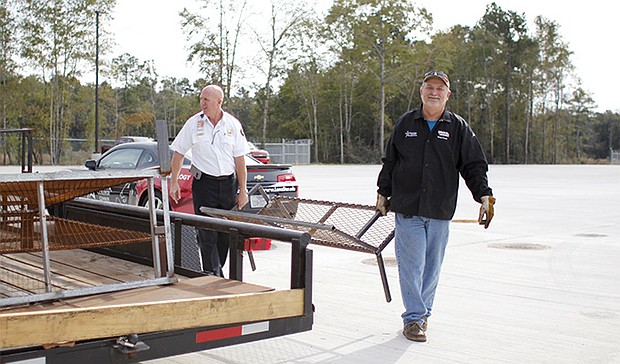 (from left to right: Conroe Fire Chief Ken Kreger and LSC-Conroe Center Professor Bobby Pecore) Welding faculty from Lone Star College-Conroe Center deliver donated prop furniture designed and built by welding students for the new seven-story City Of Conroe Fire Training Facility.