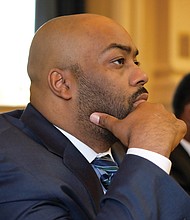 Delegate Lamont Bagby, new chair of the 20-member Virginia Legislative Black Caucus, thoughtfully watches his colleagues. 