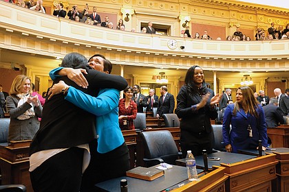 New delegates Dawn M. Adams of Richmond and Hala S. Ayala of Woodbridge share a happy embrace. They are among the 34 female legislators —  28 in the House and six in the Senate — a record for the General Assembly.
