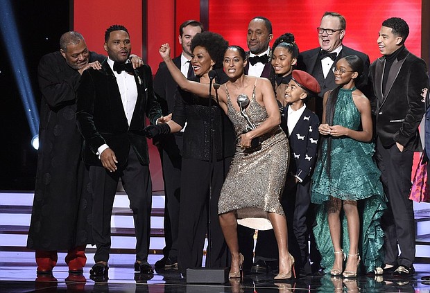 The cast and crew of “black-ish” accepts award for outstanding comedy series at the 49th annual NAACP Image Awards at the Pasadena Civic Auditorium, in Pasadena, Calif. Pictured from left are Laurence Fishburne, Anthony Anderson, Jeff Mecham, Jenifer Lewis, Tracee Ellis Ross, Kenya Barris, Yara Shahidi, Miles Brown, Peter Mackenzie, Marsai Martin, and Marcus Scribner (Credit: Photo by Chris Pizzello/Invision/AP/Shutterstock)