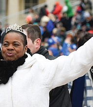 Deborah Pratt of the Eastern Shore, who holds the title of Virginia’s fastest oyster shucker, waves to the crowd during the parade.