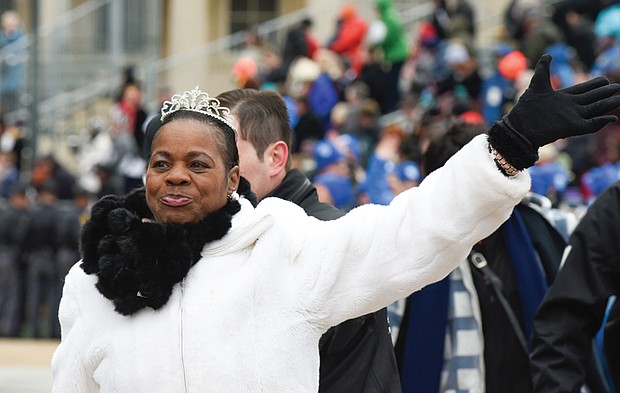 Deborah Pratt of the Eastern Shore, who holds the title of Virginia’s fastest oyster shucker, waves to the crowd during the parade.