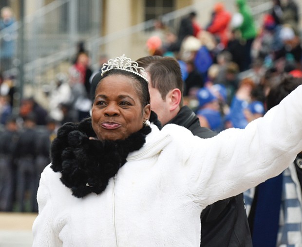 Deborah Pratt of the Eastern Shore, who holds the title of Virginia’s fastest oyster shucker, waves to the crowd during the parade.