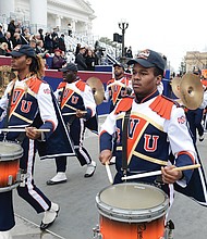 The Virginia State University Trojan Explosion Marching Band carries the beat during the 25-unit inaugural parade.