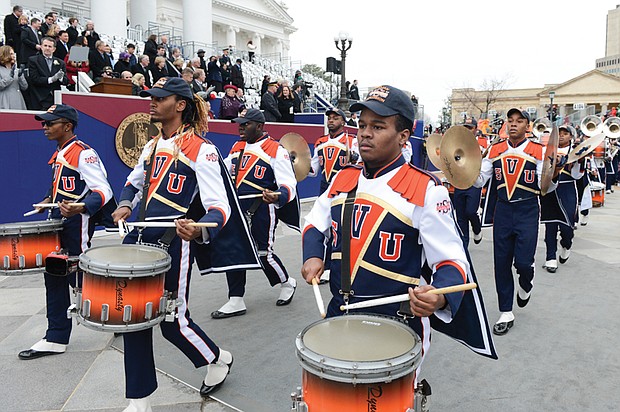 The Virginia State University Trojan Explosion Marching Band carries the beat during the 25-unit inaugural parade.