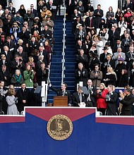 By tradition, former Gov. Terry McAuliffe, top left, slips out of the inaugural ceremony when new Gov. Ralph S. Northam takes the podium to address the crowd for the first time as the state’s chief executive.