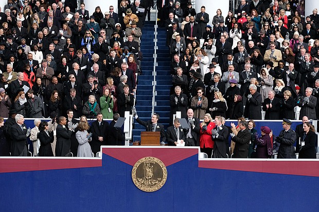 By tradition, former Gov. Terry McAuliffe, top left, slips out of the inaugural ceremony when new Gov. Ralph S. Northam takes the podium to address the crowd for the first time as the state’s chief executive.