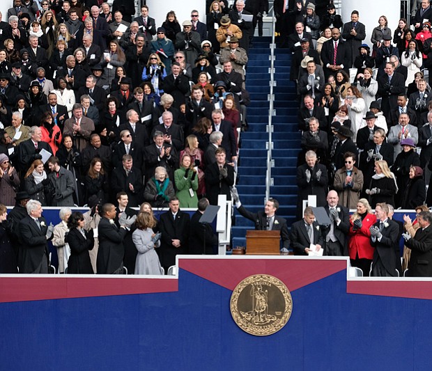 By tradition, former Gov. Terry McAuliffe, top left, slips out of the inaugural ceremony when new Gov. Ralph S. Northam takes the podium to address the crowd for the first time as the state’s chief executive.