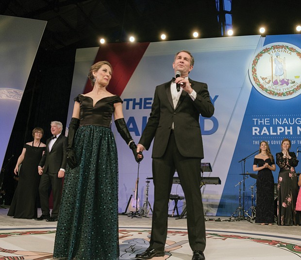 With his wife, Pam Northam, at his side, Gov. Ralph S. Northam addresses the crowd at the inaugural ball Saturday night before leading his wife in a dance around the floor. Behind him are, at left, Attorney General Mark R. Herring and his wife, Laura, and, at right, Lt. Gov. Justin E. Fairfax and his wife, Cerina.