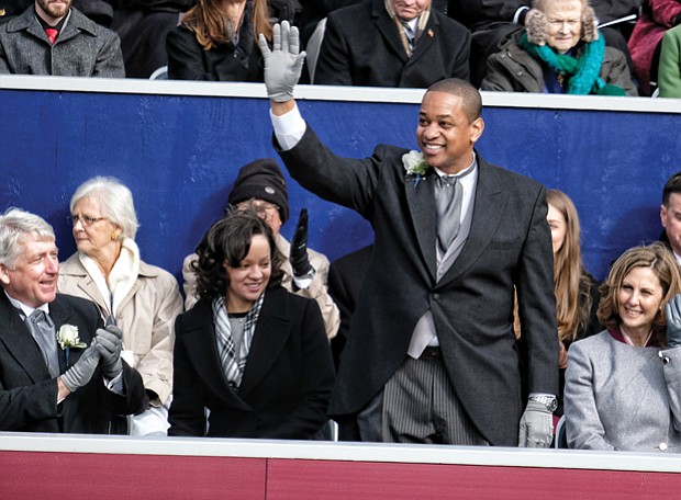 Lt. Gov. Justin E. Fairfax, only the second African-American to be elected to statewide office in Virginia, waves to a cheering crowd after taking the oath of office. His wife, Dr. Cerina Fairfax, a dentist, seated at left, held the Bible while their two children watched. Seated with him on the platform are, from left, Attorney General Mark R. Herring, Pam Northam and her husband, Gov. Ralph S. Northam.
