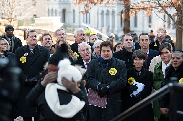 Dueling gun rallies //
Kaaleah Jones, front left, whose father was shot and killed in Newport News, gets a hug after speaking at a vigil and rally Monday in Capitol Square urging tougher state laws to curb gun violence. 
Gov. Ralph S. Northam, seen at right among the crowd, also spoke at the rally sponsored by the Virginia Center for Public Safety. Many state lawmakers attended the afternoon event that called for universal background checks before all gun purchases.
Gov. Northam and others pledged to continue their support for such laws despite the fact that measure and 19 other gun control proposals were killed just hours earlier by a Senate committee.
Earlier on Monday, Congressman Dave Brat and fellow Republican state lawmakers attended a rally at the Bell Tower in support of gun rights and their expansion. That rally was sponsored by the Virginia Citizens Defense League, a pro-gun rights group that describes itself as “more radical than the National Rifle Association.”
