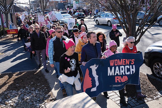 Gov. Ralph S. Northam, second from left, holds the banner with organizers at last Saturday’s Women’s March RVA in Carytown. More than 3,000 marchers turned out for the demonstration.