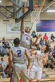 Dominique Finney, a 6-foot-5 junior at Armstrong High School, goes up for a basket at Tuesday night’s game against Hanover County’s Lee-Davis High School.