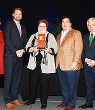 Shelley Johnson, executive director/CEO of the Lake Charles/Southwest Louisiana Convention & Visitors Bureau (center) receives the Will Mangham Tourism Lifetime Achievement Award as presented by (left to right) Jill Kidder, president/CEO of the Louisiana Travel Association (LTA); Travis Napper, president/CEO of the Ruston Lincoln CVB and LTA chairman; Lt. Gov. Billy Nungesser; and Mark Romig, New Orleans Tourism Marketing Corporation president/CEO and past LTA chairman.