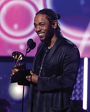 Below, Kendrick Lamar accepts the Grammy for best rap album for “DAMN.”