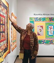 ‘Round Robin’ quilt exhibit at Pine Camp //
Cam Jones of the Kuumba African American Quilting Guild of Richmond examines a quilt made by fellow guild member Gloria Lewis during last Friday’s opening of the group’s exhibition, “Round Robin,” at Pine Camp Arts and Community Center in North Side. The exhibition is part of the center’s Black History Month celebration. Each member of the group created a center block of the quilt to establish a theme. Then, each month, the quilt was passed to another member to add a border until the top was done. The quilt then was completed by the original member. The exhibit, which runs through March 2, is free and open to the public. 
