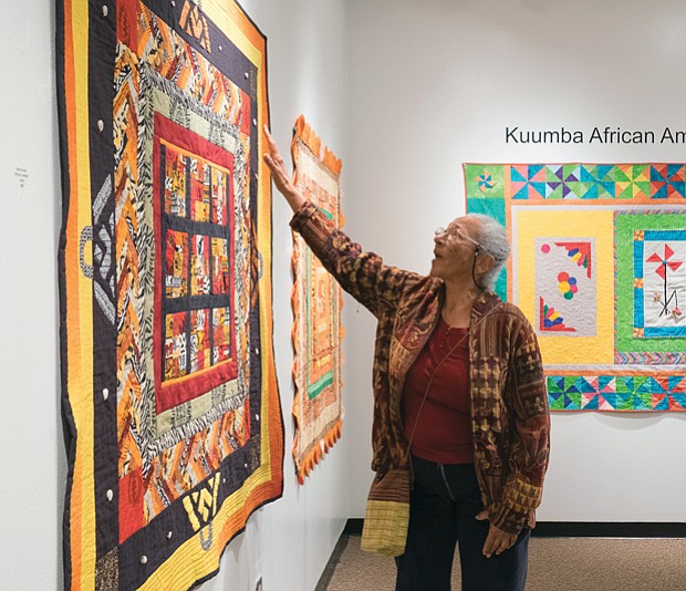 ‘Round Robin’ quilt exhibit at Pine Camp //
Cam Jones of the Kuumba African American Quilting Guild of Richmond examines a quilt made by fellow guild member Gloria Lewis during last Friday’s opening of the group’s exhibition, “Round Robin,” at Pine Camp Arts and Community Center in North Side. The exhibition is part of the center’s Black History Month celebration. Each member of the group created a center block of the quilt to establish a theme. Then, each month, the quilt was passed to another member to add a border until the top was done. The quilt then was completed by the original member. The exhibit, which runs through March 2, is free and open to the public. 