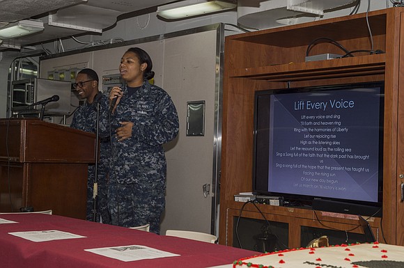 Aviation Machinist's Mate 1st Class Rhea Dias, from Mandeville, Jamaica, sings "Lift Every Voice" during an African American/Black History Month …