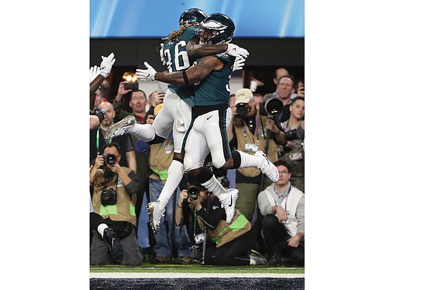 the Philadelphia Eagles’ Corey Clement, right, celebrates his touchdown with running back Jay Ajayi during Sunday’s Super Bowl game