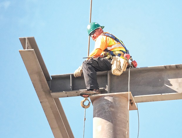 CITYSCAPE // Remember the burst of warmth in January? 
These photos were taken on Jan. 23, when the temperature soared to a balmy 73 degrees. Iron workers dressed in shirtsleeves are connecting steel beams to form the skeleton of a new residence hall going up at 10th and Leigh streets on the medical campus of Virginia Commonwealth University.