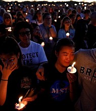People attend a candlelight vigil for victims of the shooting at nearby Marjory Stoneman Douglas High School, in Parkland, Florida, February 15, 2018. REUTERS/Carlos Garcia Rawlins