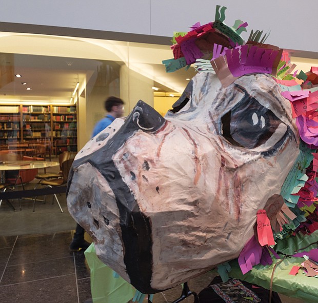 A giant papier-mâché dog’s head sits on a workbench, a symbol of the year that is to usher in a time of fairness and equality.