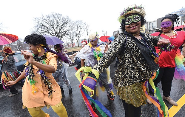 Mardi Gras style // Dogtown Dance Theatre in South Side gets the fun going during the 7th Annual Mardi Gras RVA celebration last Saturday. Members of Claves Unidos dance group kicked off the festivities with a Mardi Gras parade along five blocks in Manchester. Bringing the New Orleans style are, from left, Shalandis Wheeler Smith, Carolyn Jackson and Christina Irby. 
