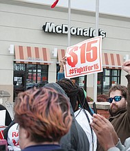 On Monday, protests were held across the nation marking the anniversary of the Memphis strike and calling for higher wages for workers. Bernadette Brown, left, holds a sign outside a Richmond fast food restaurant, while Daniel Henegar, right, and others show their support. The protests were organized by Fight for $15 and the New Poor People’s Campaign, which is led by the Rev. William J. Barber II of North Carolina.